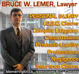 Bruce Lemer, standing  at Vancouver offices window facing the Downtown Supreme Court of BC  building on Howe St.