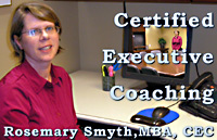 Rosemary Smyth, MBA Certified Executive Coach sitting at  work station of  Bank Investment  