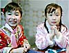 two little girls dressed and  waiting for Chinese New Year's festivities to begin in Hong Kong