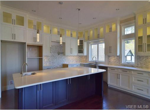 view of kitchen fr. side of island eating chairs  - 