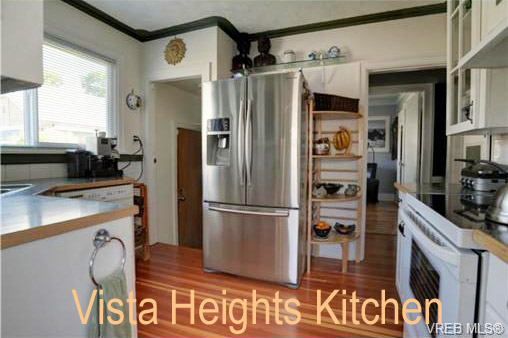 view of Vista Heights house kitchen, note renovated floors, cupboards and door to back yard